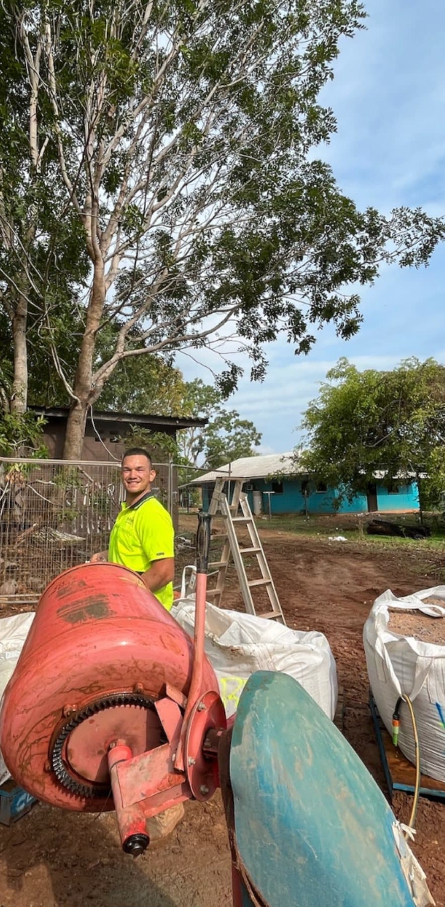 Luca working on a construction site next to a cement mixer