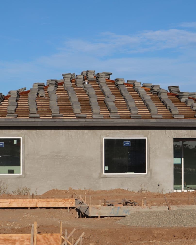 A house under construction with a newly laid tile roof