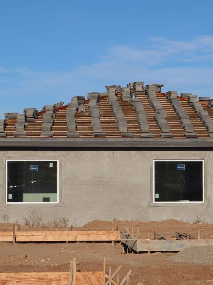 A house under construction with a newly laid tile roof